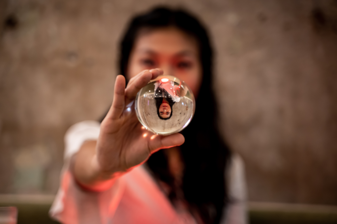 Asian woman showing a crystal sphere
