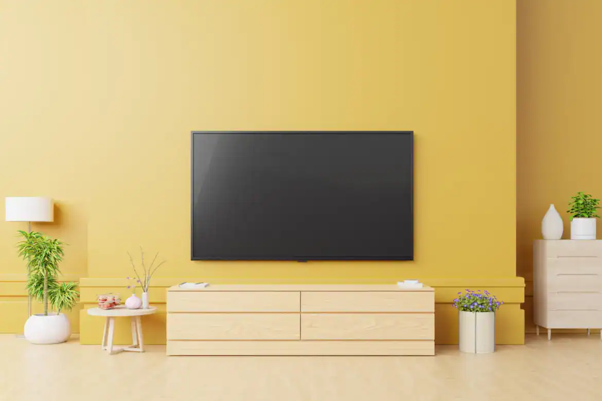 Smart Tv Mockup in modern living room with lamp,table,flower and plant on yellow wall.