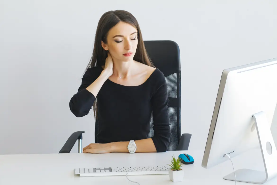 Business-Woman-suffering-from-a-neck-pain-from-bad-posture-in-her-an-office.