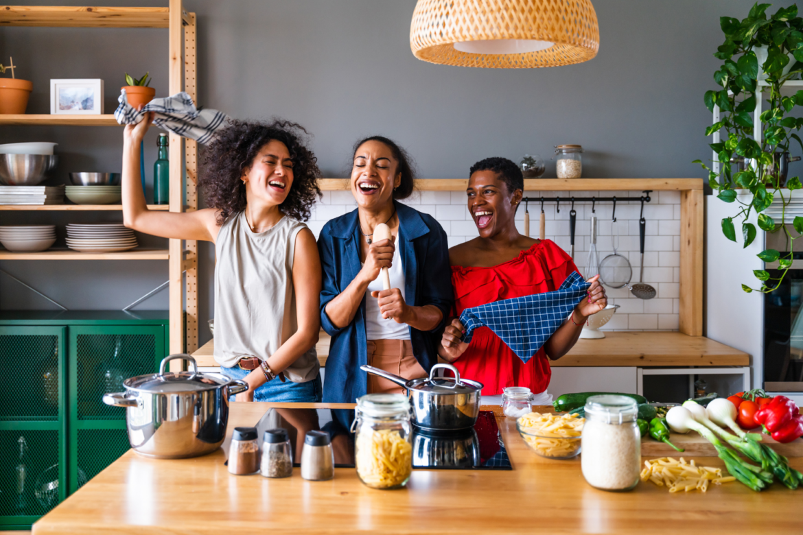 Three mixed race hispanic and black women bonding at home